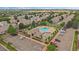 Aerial view featuring a community pool, lush trees, maintained landscaping, and convenient parking within the development at 5107 Pasadena Way, Broomfield, CO 80023