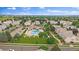 An aerial view showcases the community pool, manicured landscaping, and plentiful trees, creating a serene neighborhood at 5107 Pasadena Way, Broomfield, CO 80023