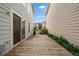 Backyard showcasing a wood deck, easy home access, complemented by lush plants and a well-maintained perimeter fence at 5107 Pasadena Way, Broomfield, CO 80023