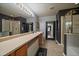 Modern bathroom with a dual vanity, a glass shower, and a soaking tub at 5107 Pasadena Way, Broomfield, CO 80023