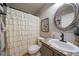 Charming bathroom featuring a decorative shower curtain, vanity, and oval mirror at 5107 Pasadena Way, Broomfield, CO 80023