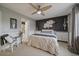 Bright bedroom featuring neutral tones, an accent wall, and a ceiling fan at 5107 Pasadena Way, Broomfield, CO 80023