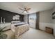 Spacious bedroom with a ceiling fan, natural light, and a decorative accent wall at 5107 Pasadena Way, Broomfield, CO 80023