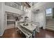 Dining room features modern lighting, open floorplan to kitchen, and seating for six at 5107 Pasadena Way, Broomfield, CO 80023