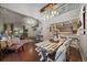 Open-concept living space with a rustic dining table, hardwood floors, and a view into the kitchen and living room at 5107 Pasadena Way, Broomfield, CO 80023