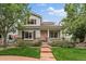 Charming two-story home featuring a quaint front porch, well-maintained lawn and beautiful landscaping at 5107 Pasadena Way, Broomfield, CO 80023