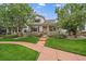Charming two-story home featuring a quaint front porch, well-maintained lawn and beautiful landscaping at 5107 Pasadena Way, Broomfield, CO 80023