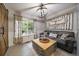 Cozy living room with barn door, modern light fixture, and comfortable seating area at 5107 Pasadena Way, Broomfield, CO 80023