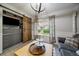 Open living room featuring a barn door accent, natural light, and unique decor at 5107 Pasadena Way, Broomfield, CO 80023