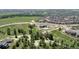 Breathtaking aerial view of the community with lush greenery, walking trails, and neighborhood pool at 8110 S Kellerman Cir, Aurora, CO 80016