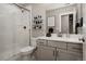 Bathroom features a glass shower, floating shelves, and a single sink vanity at 8110 S Kellerman Cir, Aurora, CO 80016