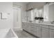 Modern bathroom with double sink vanity, sleek cabinets, and a full-width mirror at 8110 S Kellerman Cir, Aurora, CO 80016