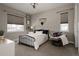 Cozy bedroom featuring a black metal bed frame, soft chair, and natural light at 8110 S Kellerman Cir, Aurora, CO 80016