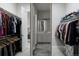Well-organized walk-in closet leads to bathroom and laundry room at 8110 S Kellerman Cir, Aurora, CO 80016