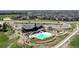 Beautiful community pool area with ample seating, mature trees, and manicured landscaping at 8110 S Kellerman Cir, Aurora, CO 80016