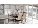 Bright dining room with elegant table set, large windows, and sliding glass doors for seamless indoor/outdoor living at 8110 S Kellerman Cir, Aurora, CO 80016