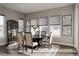 Beautiful dining room features a dark wood table, stylish chairs, modern decor, and plenty of natural light at 8110 S Kellerman Cir, Aurora, CO 80016