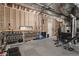 Unfinished exercise room with rubber floors and exposed ceiling at 8110 S Kellerman Cir, Aurora, CO 80016