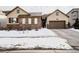 Charming two-story home with stone accents, a covered porch, and three car garage at 8110 S Kellerman Cir, Aurora, CO 80016