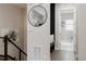 Hallway with decor mirror, coat hooks and bench seat leading to laundry room at 8110 S Kellerman Cir, Aurora, CO 80016