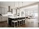 Open kitchen with a large island, modern appliances, and seating for dining at 8110 S Kellerman Cir, Aurora, CO 80016