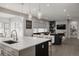 Modern kitchen with a large island, pendant lighting, and an open view to the living area at 8110 S Kellerman Cir, Aurora, CO 80016