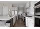Sleek kitchen featuring stainless steel appliances, white cabinetry, and a modern design at 8110 S Kellerman Cir, Aurora, CO 80016