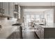 Bright kitchen featuring modern appliances, white countertops, and an adjacent dining area at 8110 S Kellerman Cir, Aurora, CO 80016