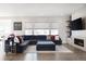 Cozy living room showcases a large sectional sofa, fireplace, built-in shelving, and an abundance of natural light at 8110 S Kellerman Cir, Aurora, CO 80016