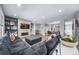 Expansive living room with a large sectional, fireplace, built-in shelves, and open layout for comfortable living at 8110 S Kellerman Cir, Aurora, CO 80016