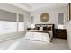 Serene main bedroom with tray ceiling, neutral tones, decorative accents, and ample natural light at 8110 S Kellerman Cir, Aurora, CO 80016