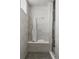 Modern tiled shower with built-in bench and a neatly folded white robe at 8110 S Kellerman Cir, Aurora, CO 80016