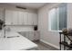 Wet bar with white countertops, undermount sink, and shaker cabinets at 8110 S Kellerman Cir, Aurora, CO 80016