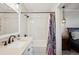 Updated bathroom includes a shower/tub combo with stylish hardware and a contemporary vanity at 48 Galapago St, Denver, CO 80223