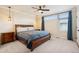 Bedroom features a ceiling fan, neutral carpet, generous windows, and en-suite bathroom at 48 Galapago St, Denver, CO 80223