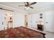 This bedroom leads to a full bathroom and features a ceiling fan, soft carpet, and a calm design at 48 Galapago St, Denver, CO 80223