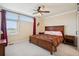 Cozy bedroom features a ceiling fan, soft carpet, ample natural light, and a comfortable sleeping space at 48 Galapago St, Denver, CO 80223