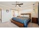 Charming bedroom featuring a ceiling fan, en-suite bathroom, soft carpet, and natural light at 48 Galapago St, Denver, CO 80223