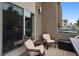 This outdoor deck space offers a cozy retreat with chairs, a small table, and convenient outdoor storage at 48 Galapago St, Denver, CO 80223