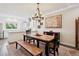 Dining room showcasing hardwood floors and an open view of the modern kitchen at 48 Galapago St, Denver, CO 80223