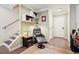 Hallway featuring hardwood floors, comfortable arm chair, and staircase at 48 Galapago St, Denver, CO 80223