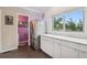 Bright, well-lit kitchen featuring white cabinets, stainless steel refrigerator and views out of the kitchen window at 48 Galapago St, Denver, CO 80223
