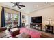 Cozy living room featuring hardwood floors, ceiling fan, and sliding glass doors to balcony at 48 Galapago St, Denver, CO 80223