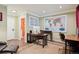 Office featuring hardwood floors, map decor, and desk with computer setup at 48 Galapago St, Denver, CO 80223