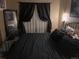 Comfortable bedroom showcasing dark curtains and a cozy bed at 6711 S Ivy Way # B5, Centennial, CO 80112