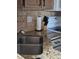 Functional kitchen showcasing stainless steel sink, granite counters and stylish backsplash at 6711 S Ivy Way # B5, Centennial, CO 80112
