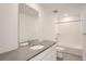 Well-lit bathroom featuring modern vanity with gray countertop, mirror, and shower-tub combo at 2058 S Haleyville Way, Aurora, CO 80018