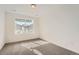 Cozy bedroom with plush carpet, white walls, neutral color palette, and a large window offering neighborhood views at 2058 S Haleyville Way, Aurora, CO 80018