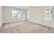 Bright bedroom featuring plush carpet, white walls, and a large window offering neighborhood views at 2058 S Haleyville Way, Aurora, CO 80018