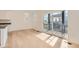 Bright living space featuring natural light, hardwood floors, and a sliding door leading to a balcony at 2058 S Haleyville Way, Aurora, CO 80018